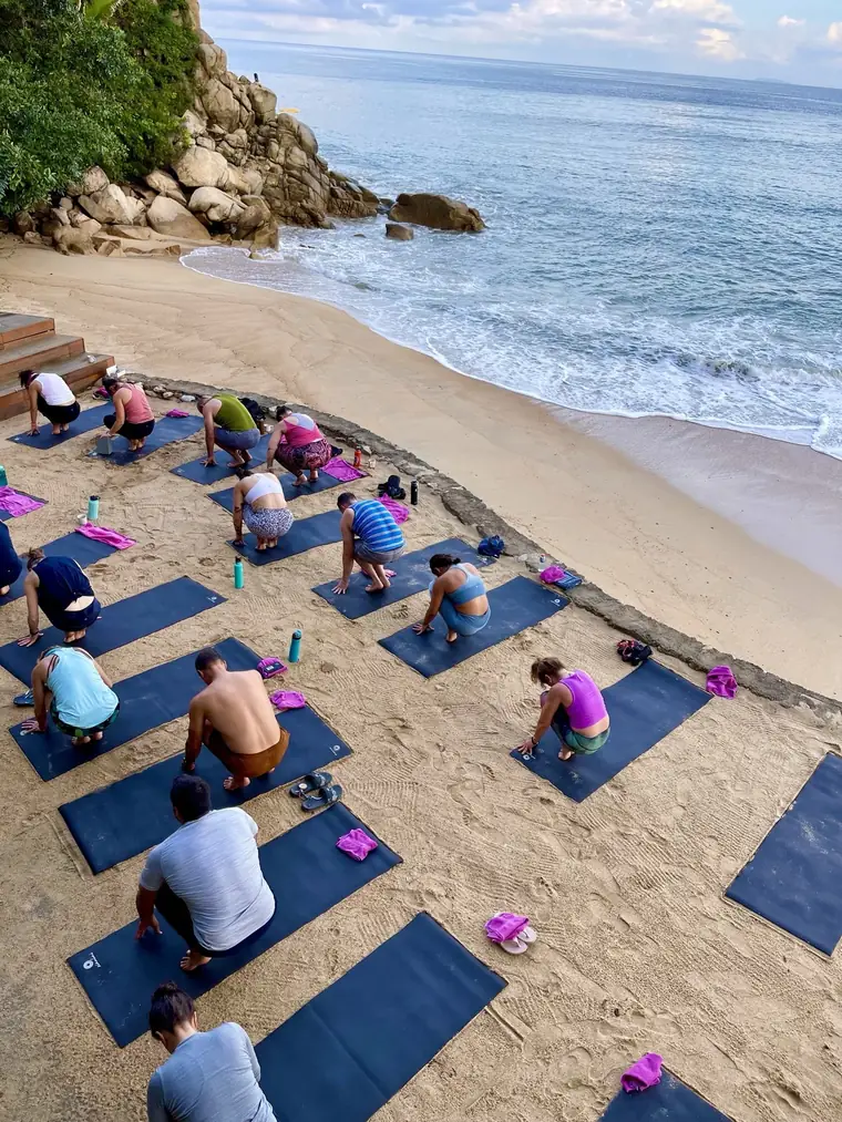 A full beach yoga class at the retreat
